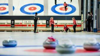La pierre de curling est poussée